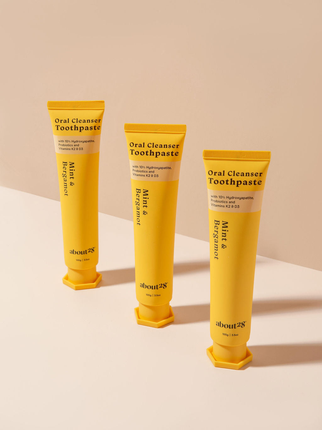 three natural hydroxyapatite toothpaste tubes, brand is About28 Oral Cleanser, mint and bergamot flavour fluoride-free